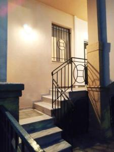 a set of stairs leading to a building with a window at Comfy Alykes Apartment, Volos in Volos