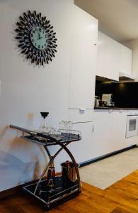 a clock hanging on a wall in a kitchen at Wien-Appartement, Contactless - Self-Check-In in Vienna