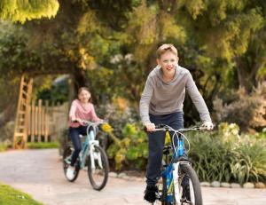 a woman riding a bike with two children at Hyatt Regency Monterey Hotel and Spa in Monterey