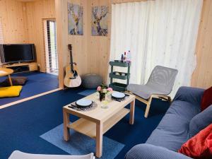 a living room with a couch and a table at Sunhouse - Vacation STAY 28595v in Yachimata