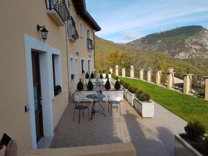a patio with tables and chairs in a building at Borgo Donna Teresa in Castel San Vincenzo