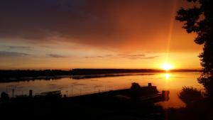 a sunset over a river with the sun setting at Хотелски комплекс Радецки град Козлодуй in Kozloduy