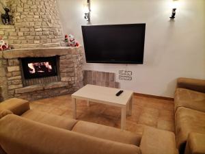 a living room with a couch and a fireplace at Encant Rural a Cal Japet in Fonollosa