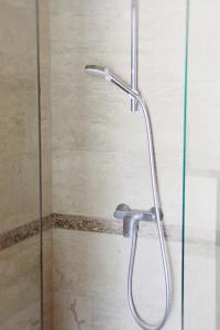 a shower with a glass door in a bathroom at Apartment Sunset in Kotor