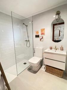 a bathroom with a shower and a toilet and a sink at El Maltés in Cudillero +21 photos