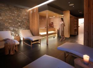 a woman standing in a room with a massage room at RESORT VALFORMICA in Asiago