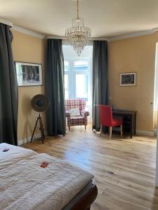 a bedroom with a bed and a desk and a chair at Pension Zur Fähre in Boppard