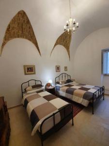 A bed or beds in a room at Casa Santa Maria - Beautifully restored house in centro storico Irsina Basilicata Puglia