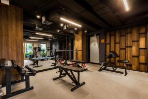 a gym with a row of treadmills and weights at Uroczy Apartament w Sercu Starego Miasta in Gdańsk