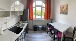 a kitchen with a table and a sink and a table and chairs at MRS in Hürth