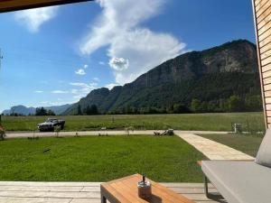 a patio with a view of a field and mountains at Seechalet Linsendorf in Saager