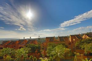 un grupo de casas con el sol en el cielo en R25 Modern bright 2 bedroom apartment, en Marbella