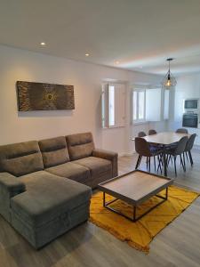 a living room with a couch and a table at Casa Giraldo sem Pavor in Évora