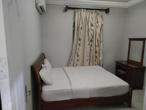 a bedroom with a white bed and a window at Hurghada Dreams in Hurghada