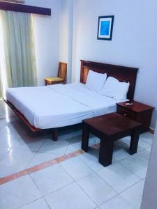 a bedroom with a large bed and a table at Hurghada Dreams in Hurghada