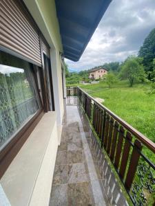 a balcony with a view of a field at Apartment Konavec in Kobarid