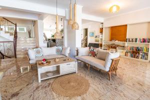 a living room with a couch and a table at Hotel Grand Nefeli in Vasiliki