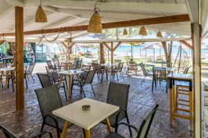 a group of tables and chairs in a restaurant at Hotel Grand Nefeli in Vasiliki