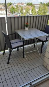 a table and a chair on a balcony with a table and a bench at # STUDIO BON EMPLACEMENT AVEC PARKING # in Illzach
