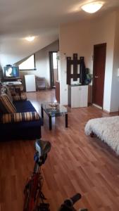 a living room with a couch and a table at Апартамент студио в затворен комплекс в гр.Банско in Bansko