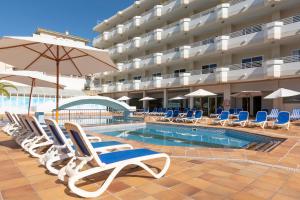 a pool with chairs and an umbrella next to a hotel at Mar Hotels Paguera & Spa in Paguera