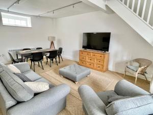 a living room with a table and a tv at The Old Post Office - central Helmsley with parking in Helmsley