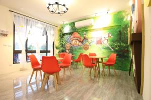 a dining room with a painting on the wall at 蘑菇奇緣民宿 in Taitung City