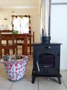 a stove in a living room with a bowl at Bell Park Self Catering in Champagne Valley