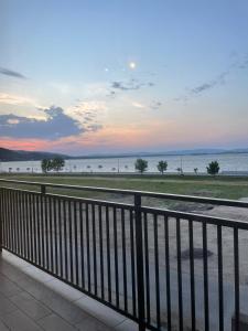 a view of the ocean from a balcony with a fence at Sun and river Apartments in Golubac
