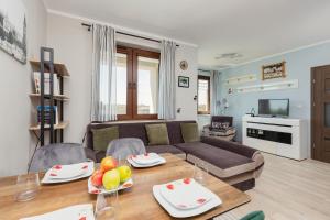 Televízia a/alebo spoločenská miestnosť v ubytovaní Apartment Na Zakolu Wisły by Noclegi Renters