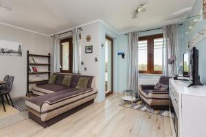 Televízia a/alebo spoločenská miestnosť v ubytovaní Apartment Na Zakolu Wisły by Noclegi Renters
