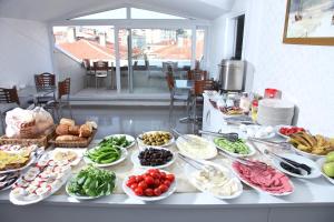 a buffet with many plates of food on a table at Çamlıca Tower Hotel in Istanbul
