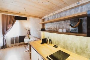 a kitchen with wooden ceilings and a counter top at Penzion Castello in Valtice