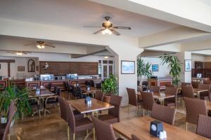 a restaurant with wooden tables and chairs at Smart Stay Beach Bodrum -All Inclusive in Gümbet