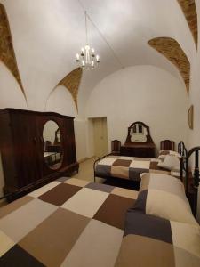 A bed or beds in a room at Casa Santa Maria - Beautifully restored house in centro storico Irsina Basilicata Puglia