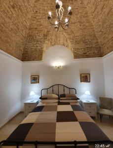 A bed or beds in a room at Casa Santa Maria - Beautifully restored house in centro storico Irsina Basilicata Puglia