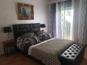 a bedroom with a large bed and a window at Villa avec piscine privée près de Casablanca Maroc in Dar Bouazza