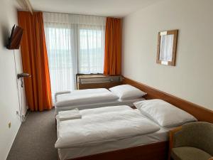 A bed or beds in a room at Retro Hotel Suza