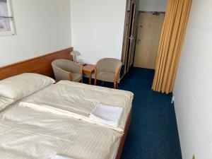 A bed or beds in a room at Retro Hotel Suza