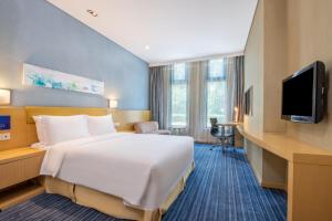 a hotel room with a large bed and a television at Holiday Inn Express Beijing Airport Zone by IHG in Beijing
