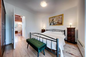 a bedroom with a bed and a bench in it at Villa Anja in Pražnice