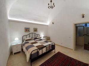A bed or beds in a room at Casa Santa Maria - Beautifully restored house in centro storico Irsina Basilicata Puglia
