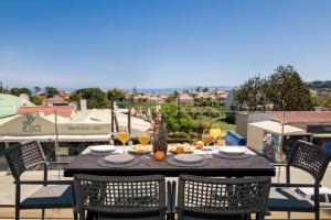 a table with food and wine glasses on a balcony at ALFA LUXURY APARTMENTS in Tsilivi