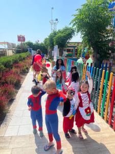 a group of children standing next to a fence at Orange County Belek in Belek