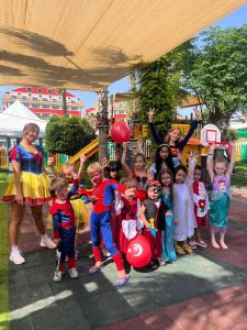 a group of children dressed in costumes posing for a picture at Orange County Belek in Belek