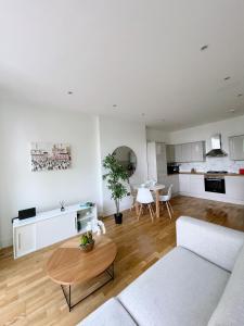 a living room with a couch and a table at Modern and light 2 bed flat in SW2 in London