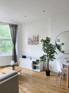 a living room with a couch and a table at Modern and light 2 bed flat in SW2 in London