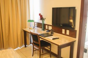 a hotel room with a desk with a television on it at Metropolitan Hotel in Teresina