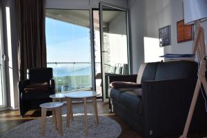 a living room with a couch and a table at NewPort Weser, NewPort Marina in Bremerhaven