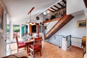 a dining room with a table and a staircase at Villa Anja in Pražnice